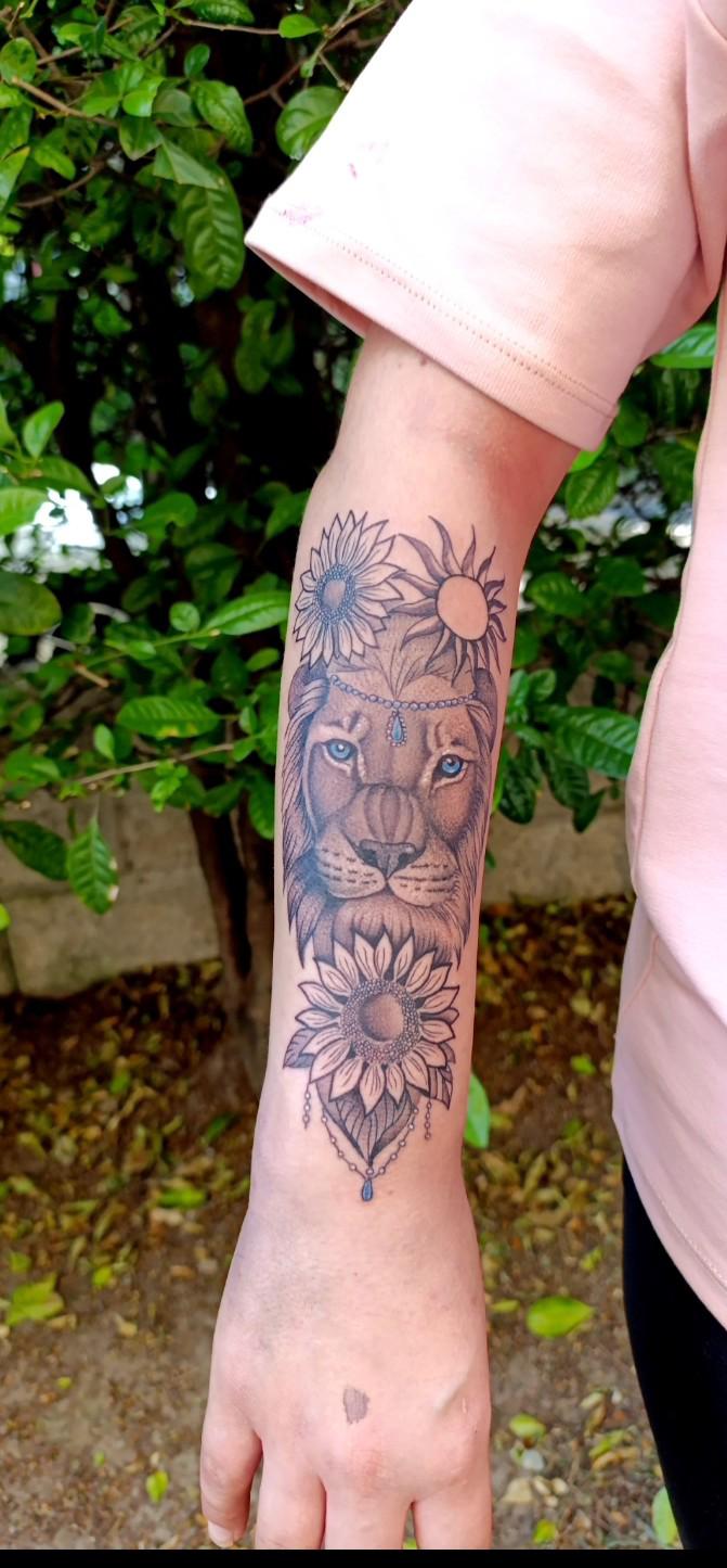Lion with sunflowers tattoo